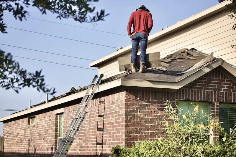 Professional roofer working on a residential roof in Harvest Hills